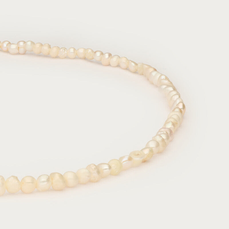 Freshwater pearls and locket necklace closeup