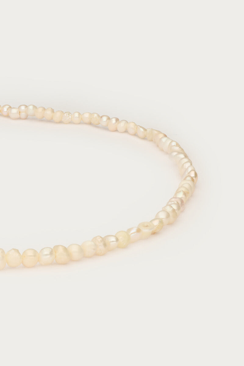 Freshwater pearls and locket necklace closeup